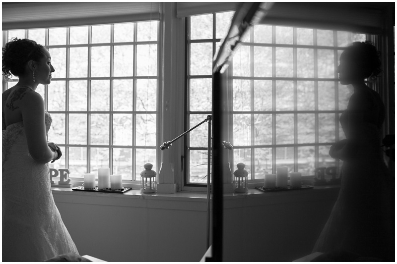 Creative reflections while a bride gets her dress zipped at Montauk Manor