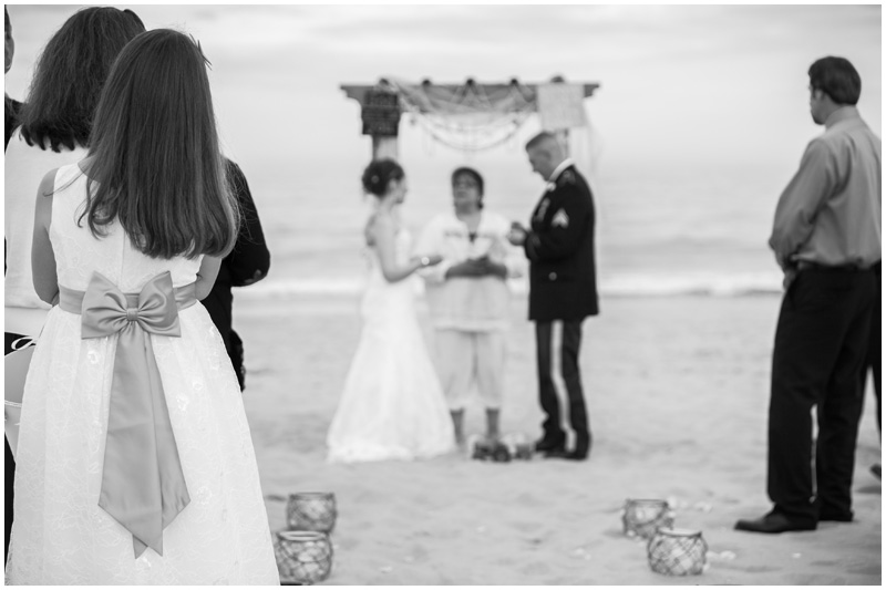 A flowergirl looks on at a sweet and small beach wedding in the Hamptons