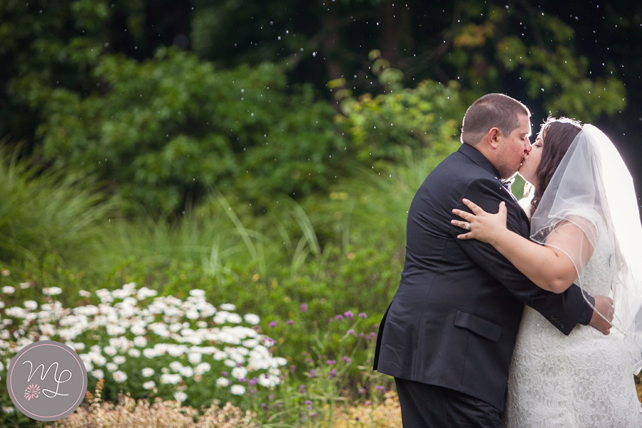 The rain didn't stop this bride and groom from enjoying their wedding day. It even made for a gorgeous picture at the Greensboro Arboretum in NC 