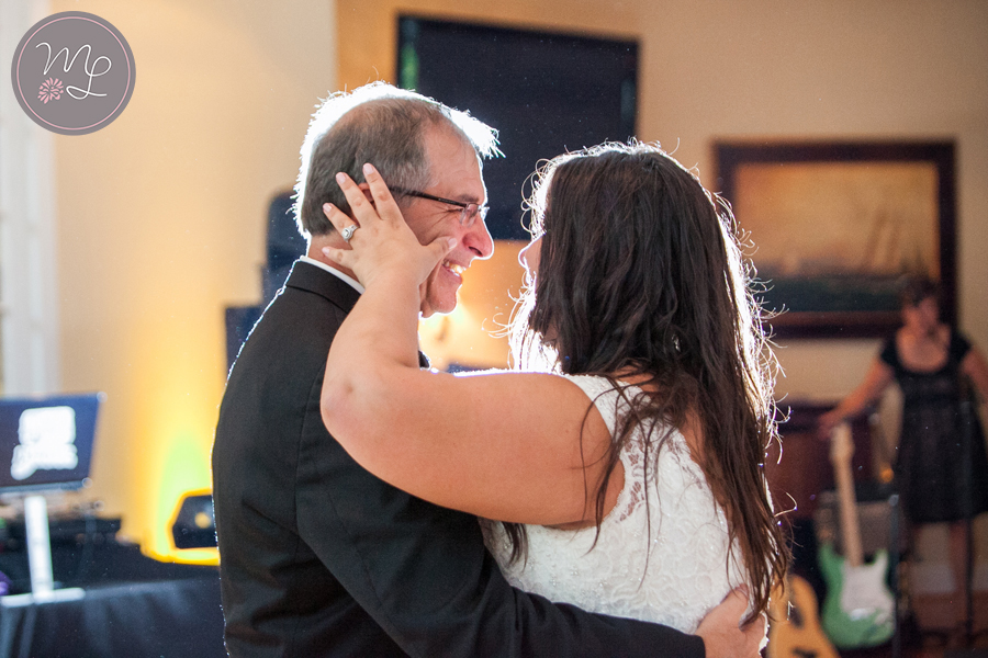 This bride wipes her fathers tears away during their father daughter dance.