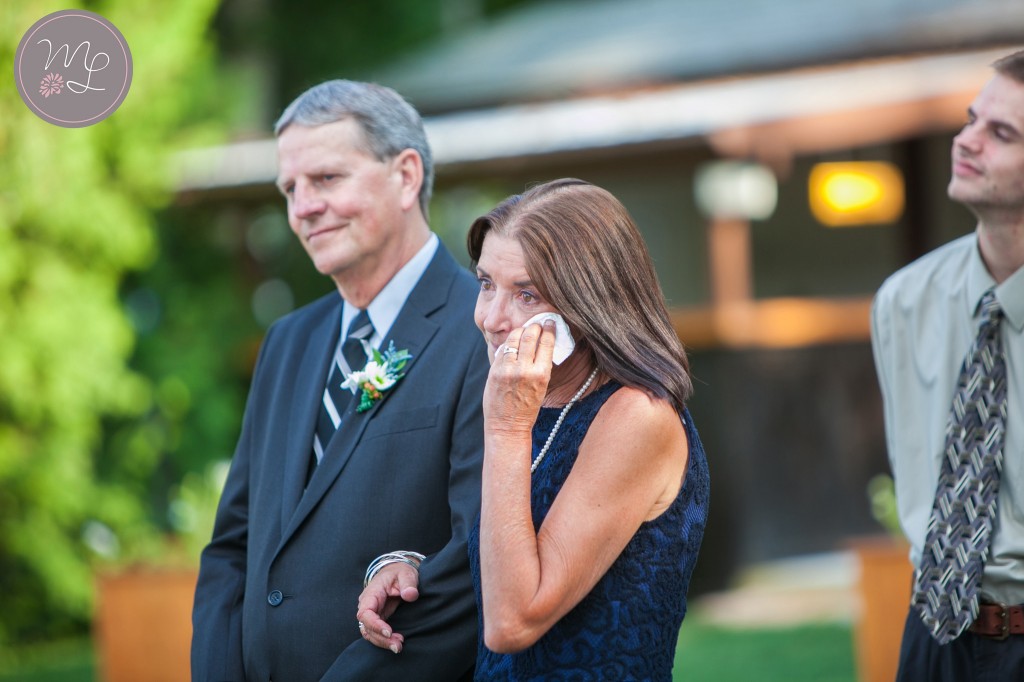 Mother of the bride wipes away happy tears at her daughter's Lake Placid wedding. Mabyn Ludke Photography