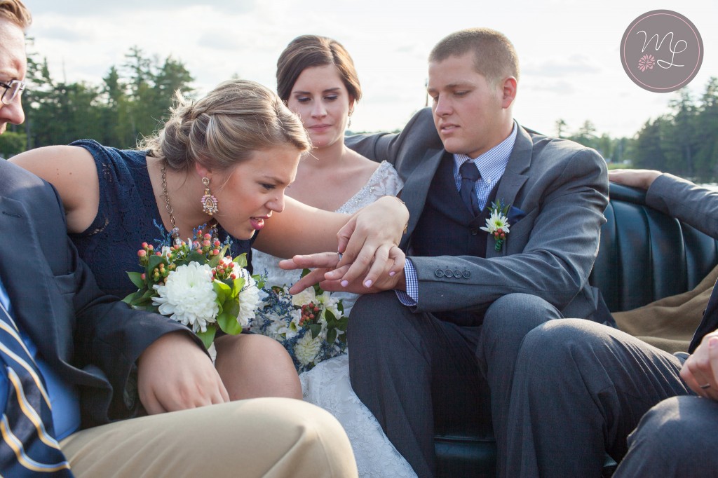The Maid of Honor investigates the grooms ring on Lake Placid. Photo by Mabyn Ludke
