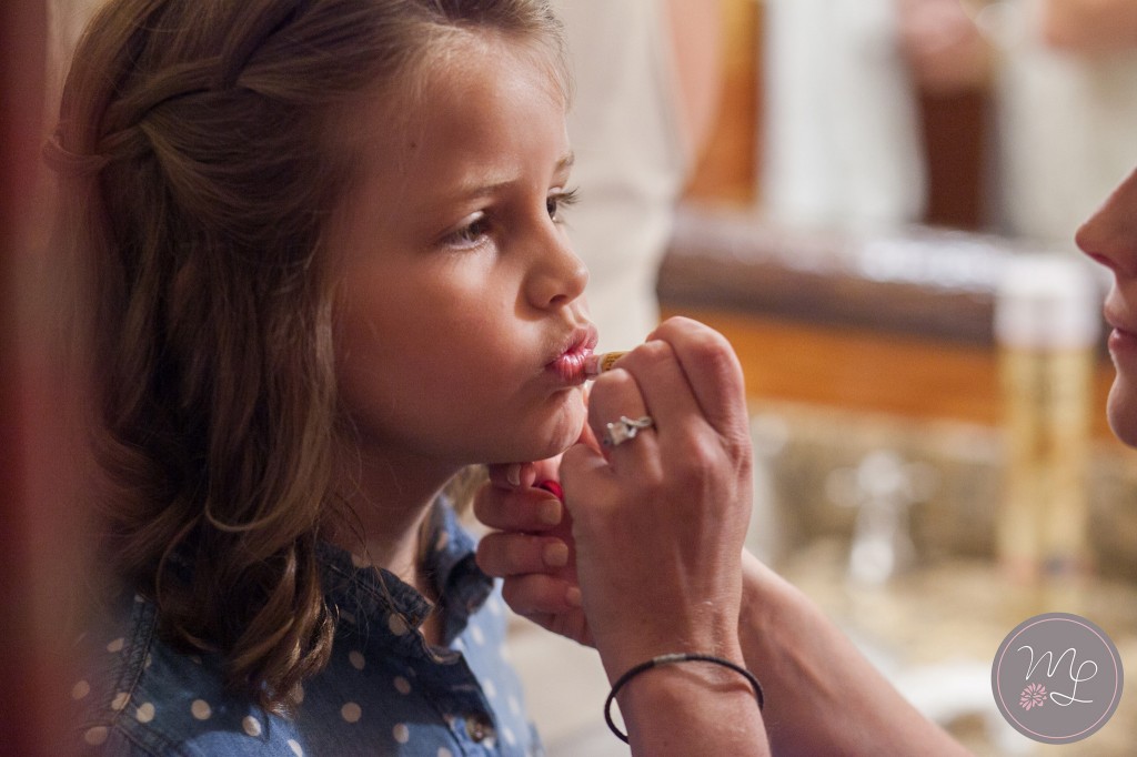 A flower girl puckers her lips for a little lip gloss at the White Face Lodge. Photo by Mabyn Ludke