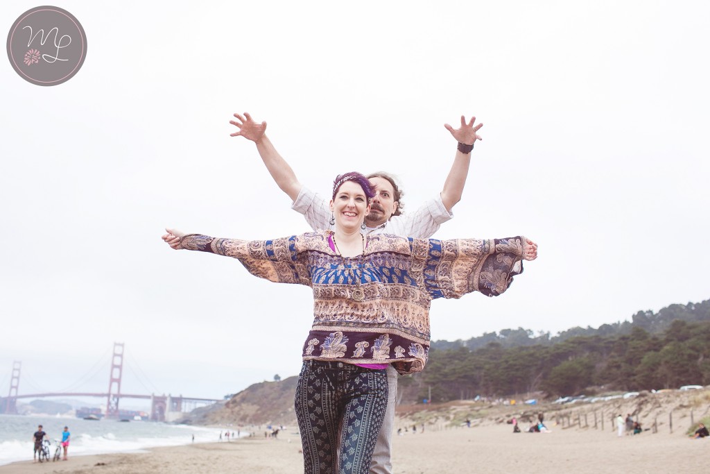 A couple gets silly on Baker Beach in San Francisco. Mabyn Ludke Photography