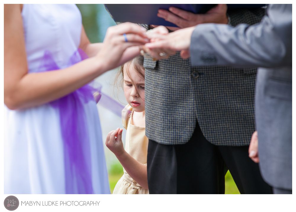 A distracted flower girl plays during the wedding ceremony. Photo by Mabyn Ludke