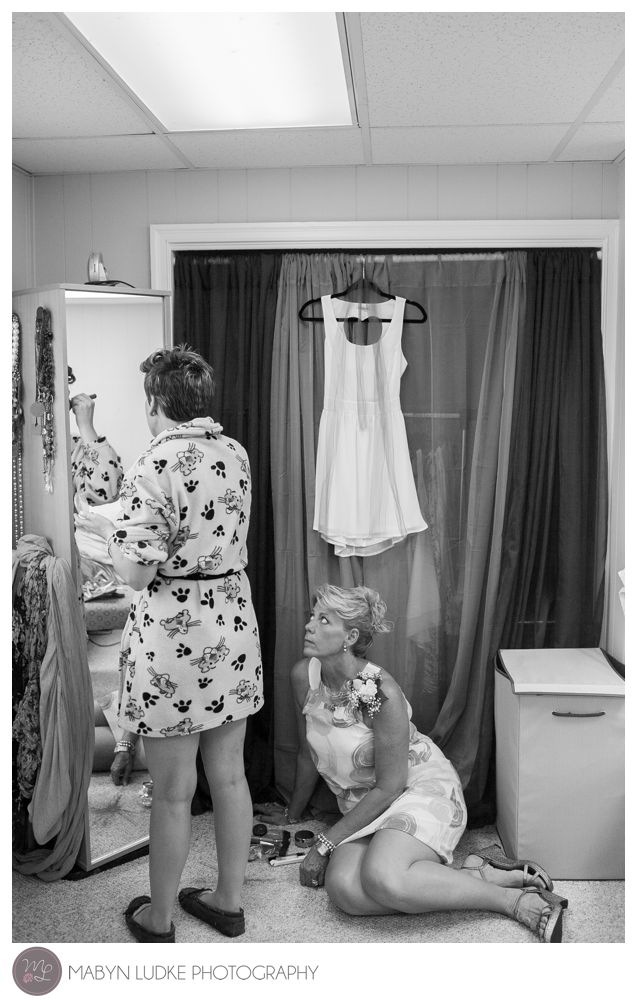 Mother of the bride looks on as her daughter gets ready for her wedding day in North Carolina. Mabyn Ludke Photography
