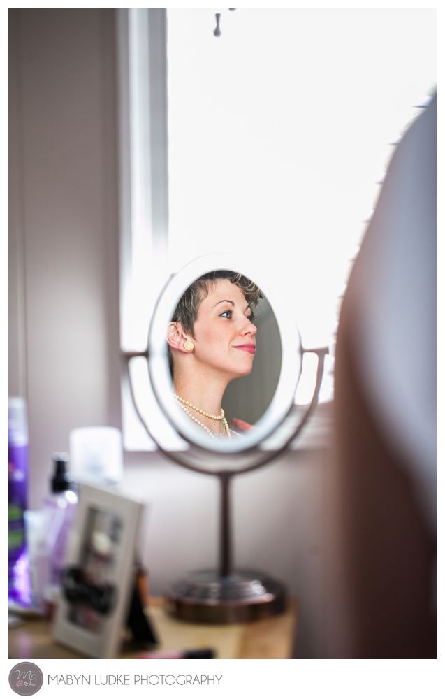 A proud bride's reflection as she gets ready for her Kernersville wedding. Photo by Mabyn Ludke
