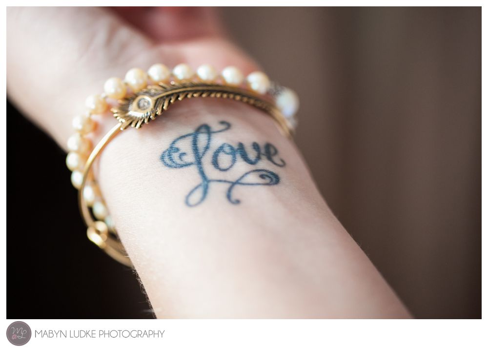 The bride's appropriate tattoo for her wedding day in Kernersville. Mabyn Ludke Photography