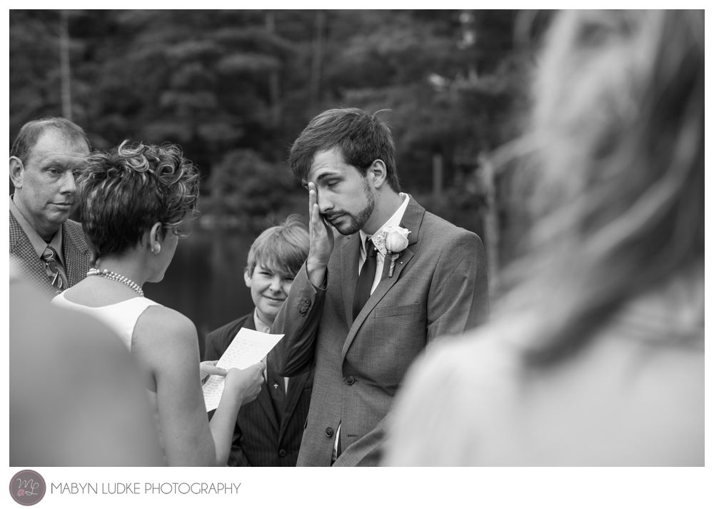 A groom wipes away tears of joy at his Kernersville wedding ceremony. Mabyn Ludke Photography
