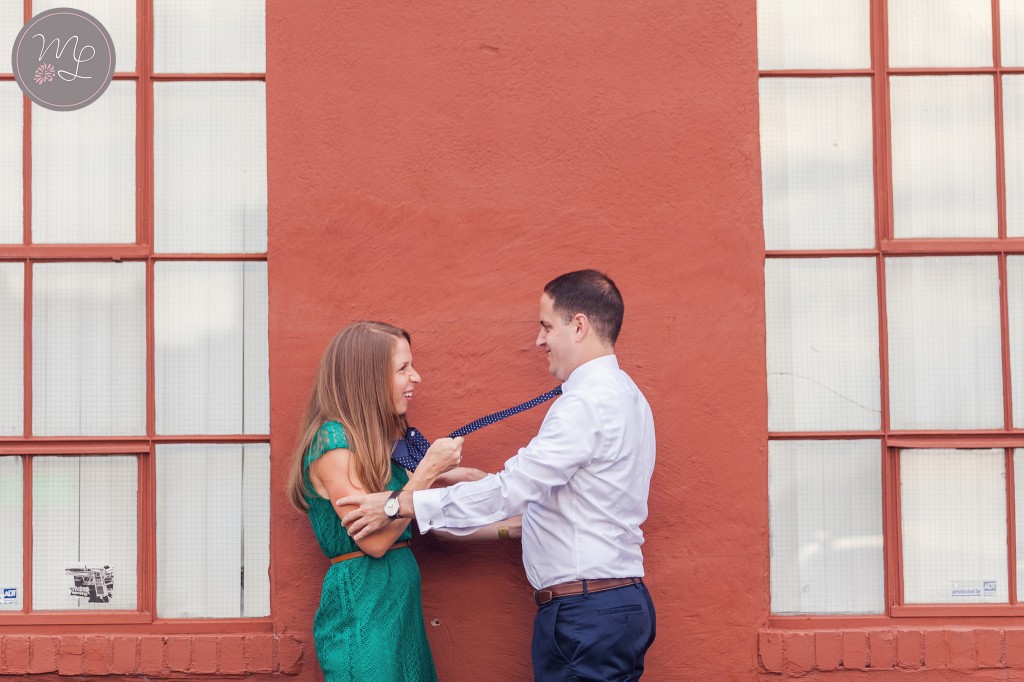 Katie tugs on Mike's tie at their Armory Square engagement session.