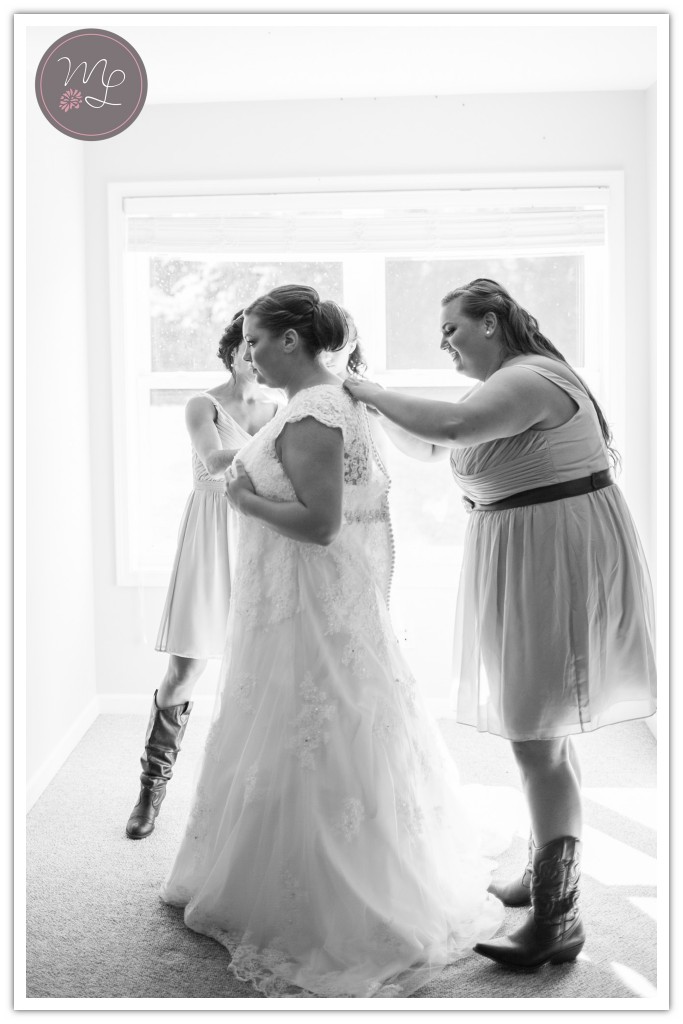 Greensboro wedding photographer, Mabyn Ludke, photographs the bride stepping into her gown.