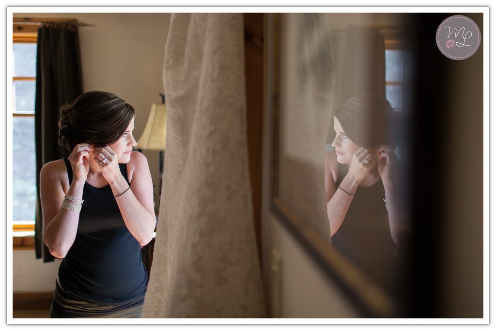 Mabyn Ludke captures a bride reflects on her wedding day while putting on her jewelry
