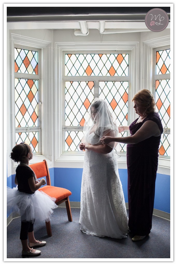 Mabyn Ludke captures an elegant moment as a mom adjusts her daughters veil in Greensboro, NC
