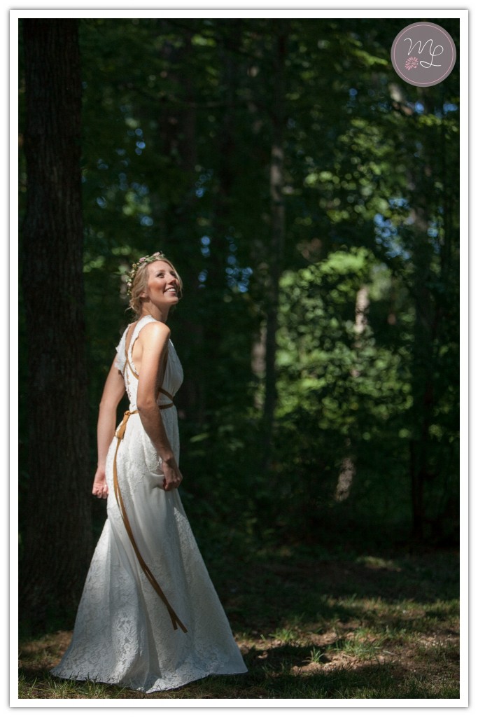 A gorgeous bride dances in the sunlight at her Oakridge, NC wedding ceremony. Mabyn Ludke Photography