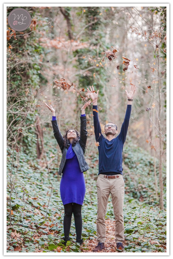 Rachna and Bharat throw leaves in the air at their winter Chapel Hill, NC engagement session.