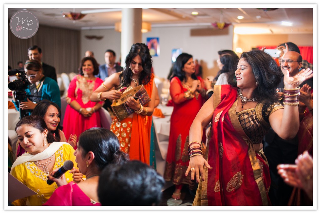 Women sing as part of this traditional Sangeet ceremony at the Sheraton of Chapel Hill.