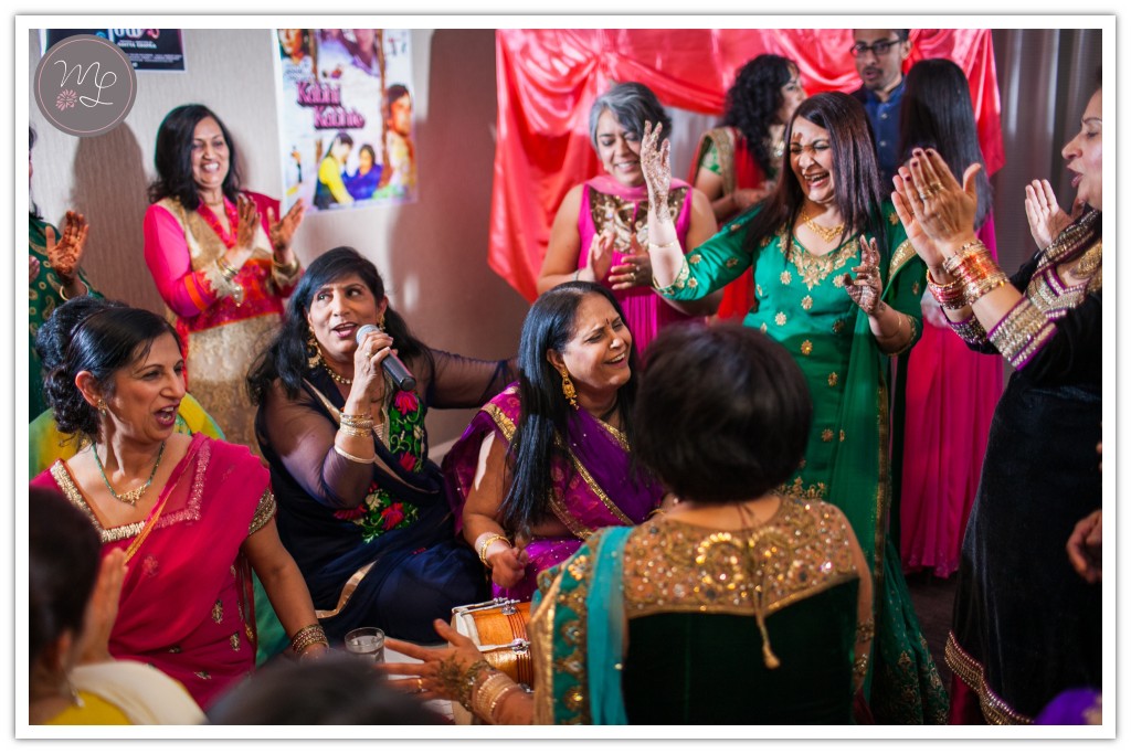 Women perform a traditional song for the bride at an Indian Sangeet in Chapel Hill, NC