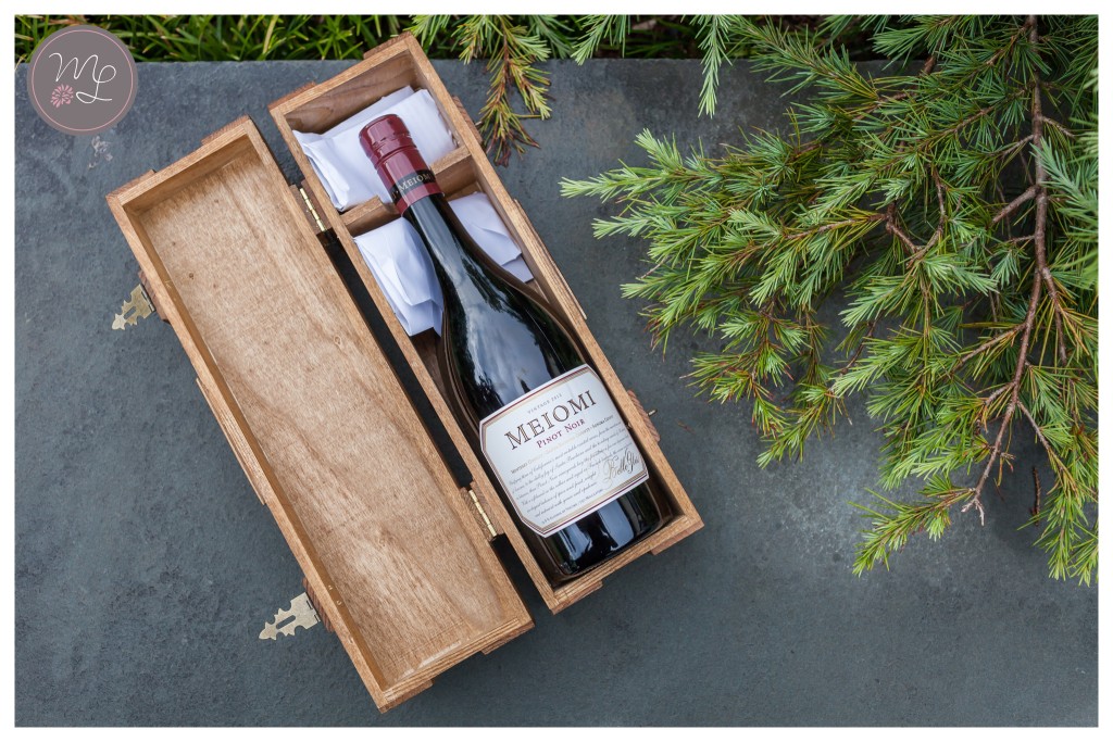 Bottle inside a carved wooden wine box for the bride and groom to open in one year. © Mabyn Ludke Photography