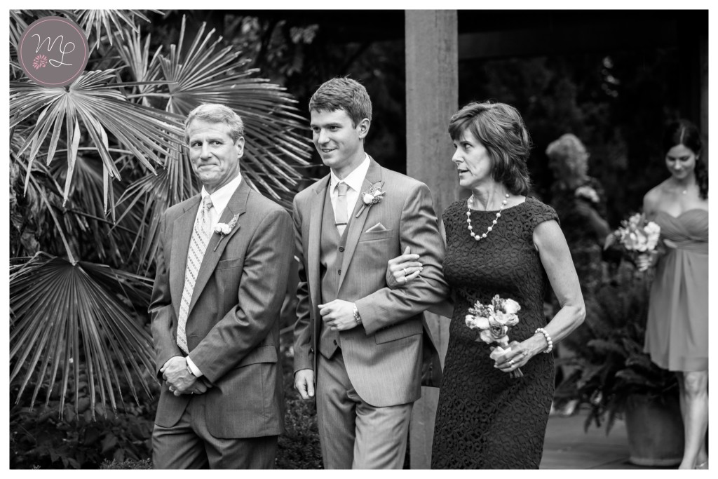 Groom and his parents walk down the aisle of their Duke Gardens wedding in Durham, NC. © Mabyn Ludke Photography