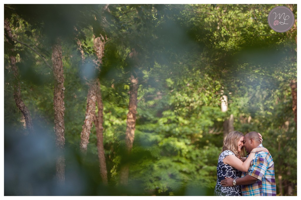 Bethany and Corey cuddle beneath the trees at their Greensboro engagement session.
