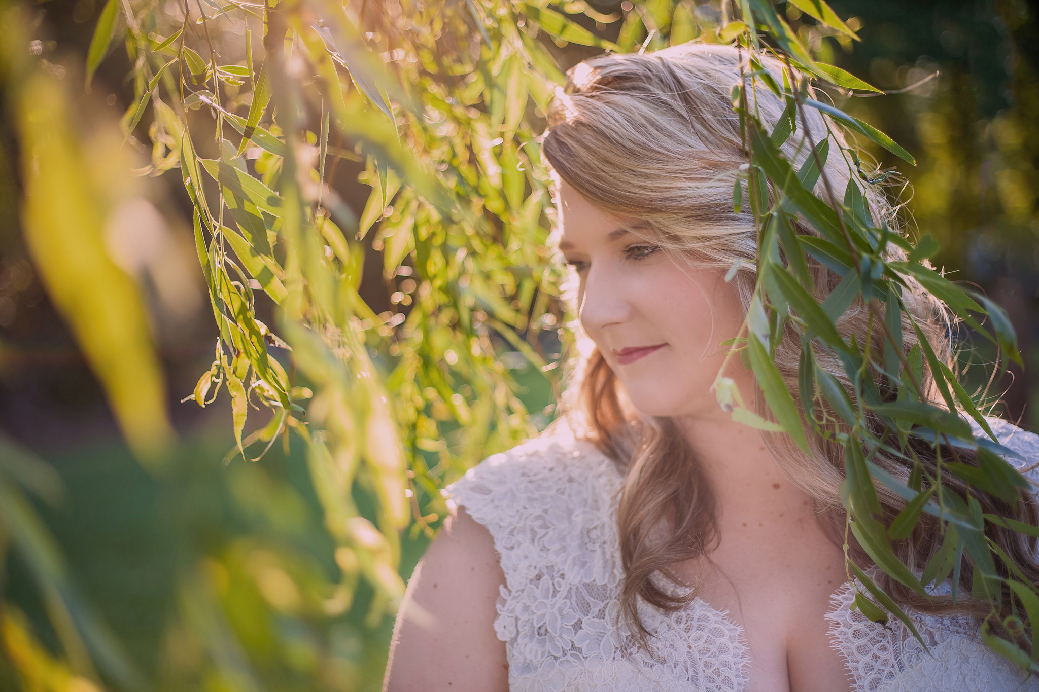 This bride is lovely as the sun filters through the trees during her Asheboro, NC bridal portrait session by Mabyn Ludke Photography