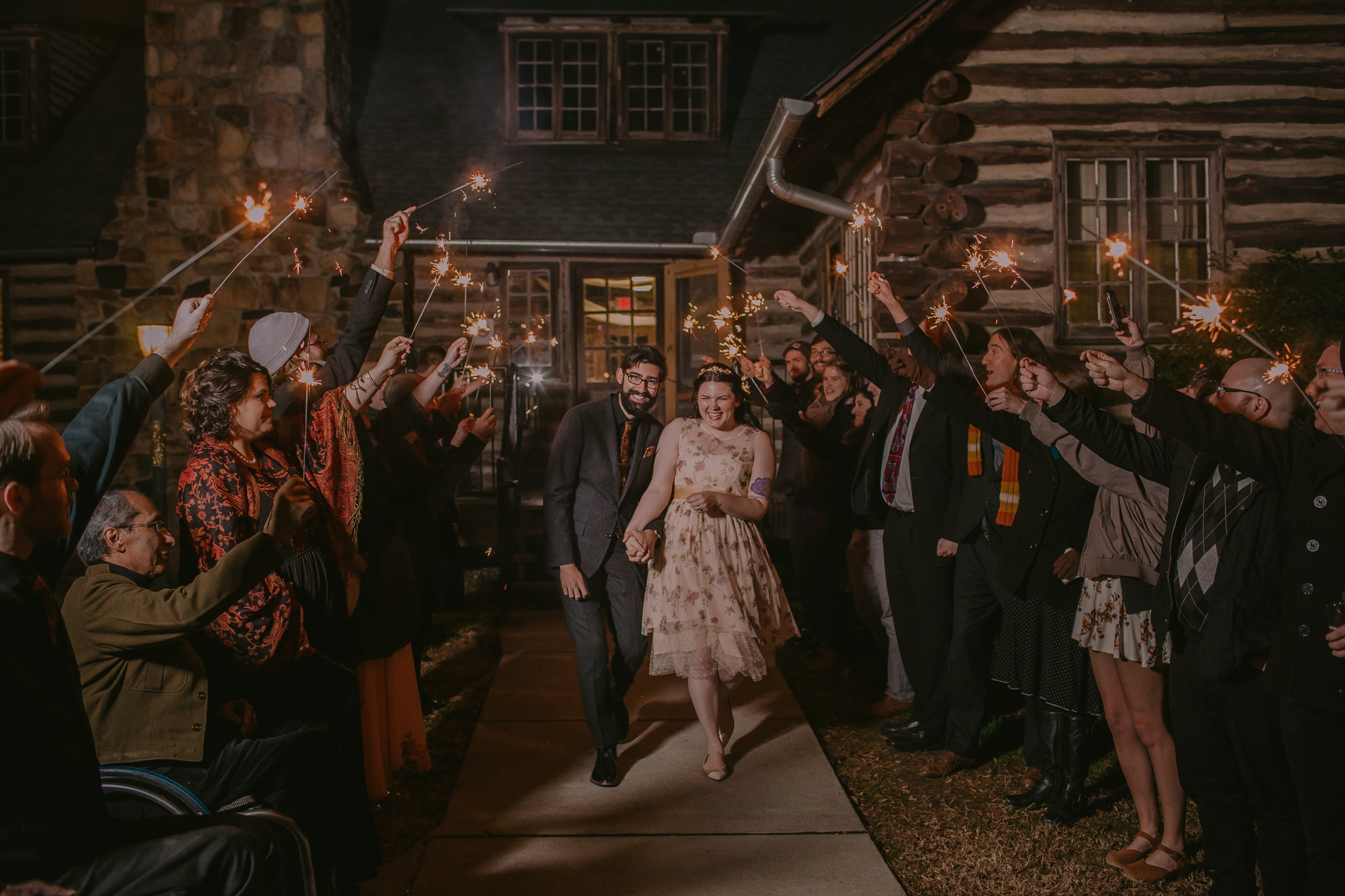 Newly married couple running through their sparkler exit at the Spruce Pine Lodge