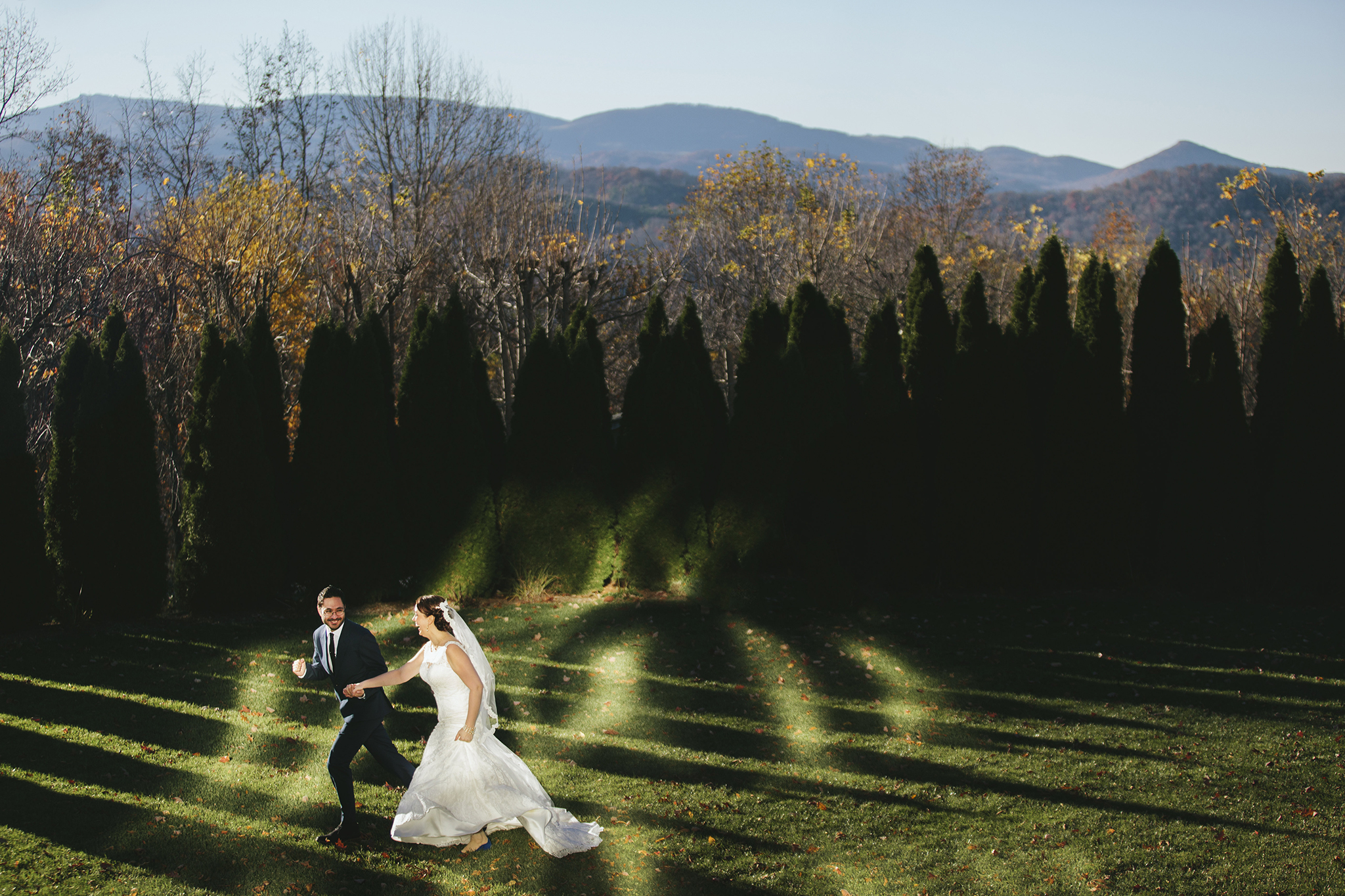 Daniel & Mabyn of Mabyn Ludke Photography run across the lawn at the Inn at Creswood where they had their Blowing Rock NC wedding
