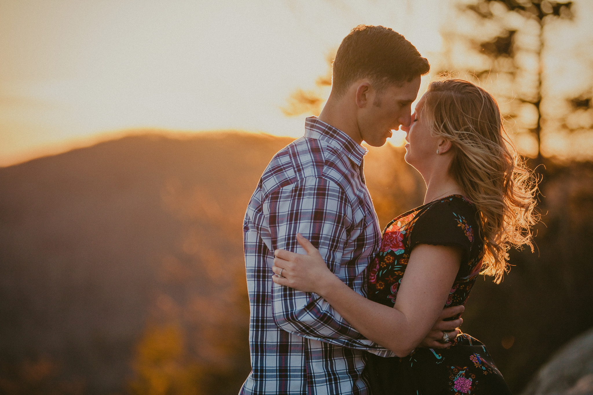 A romantic sunset kiss during this engagement session on top of the Beacon Heights Trail
