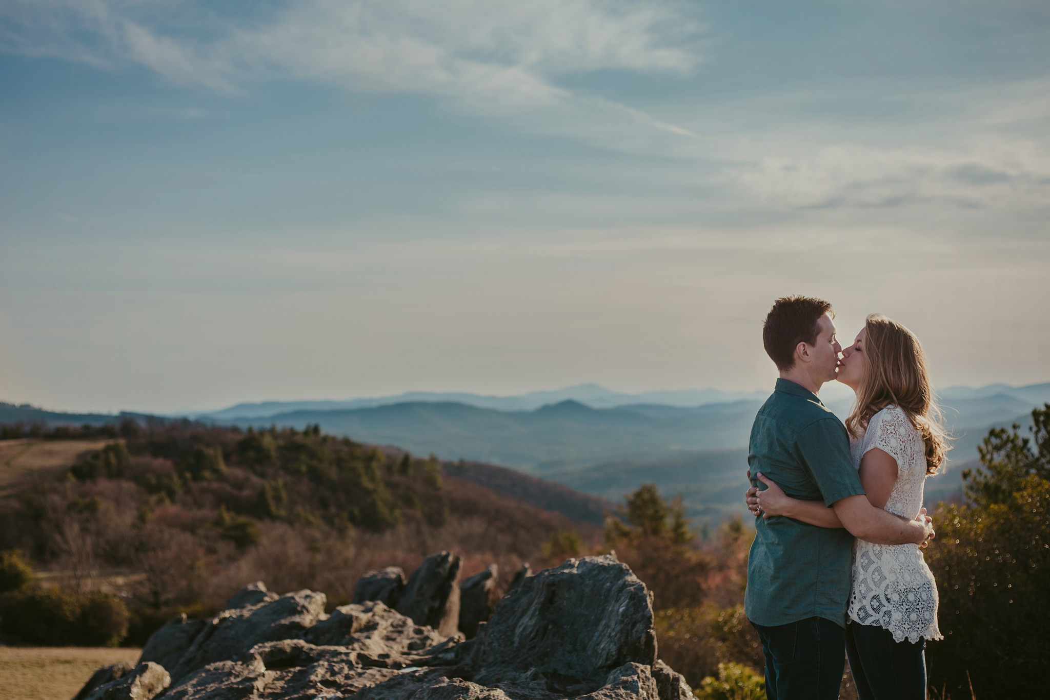 A couple kisses a top the Blue Ridge Parkway near Sparta, NC. Mabyn Ludke Photography.