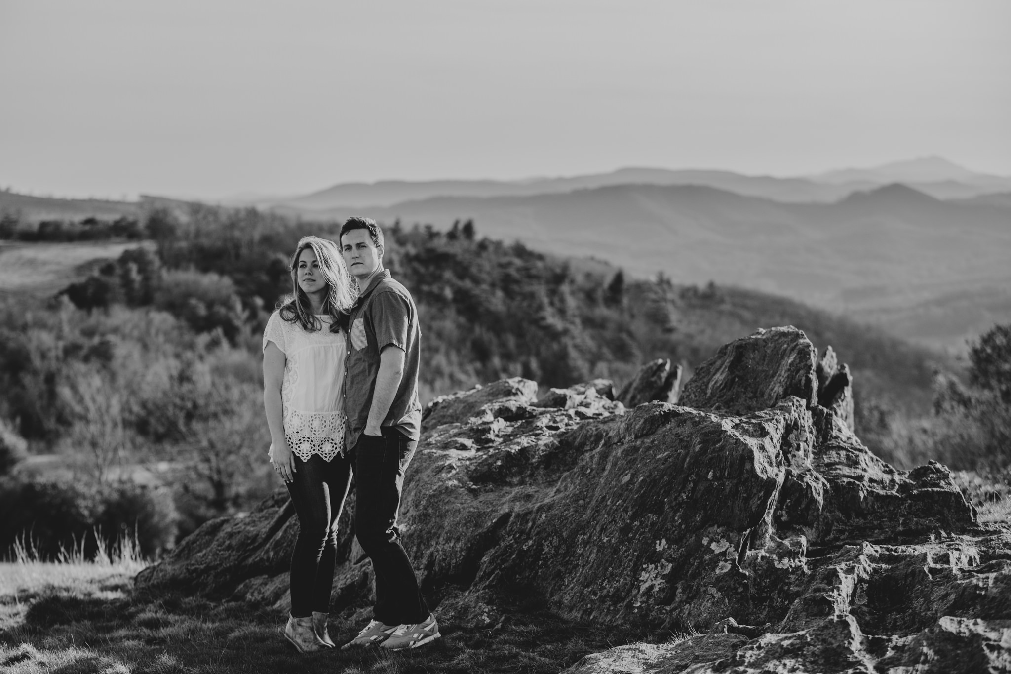 Black and White photo of a couple looking over the Blue Ridge Parkway at Doughton Park in NC. Photography by Mabyn Ludke