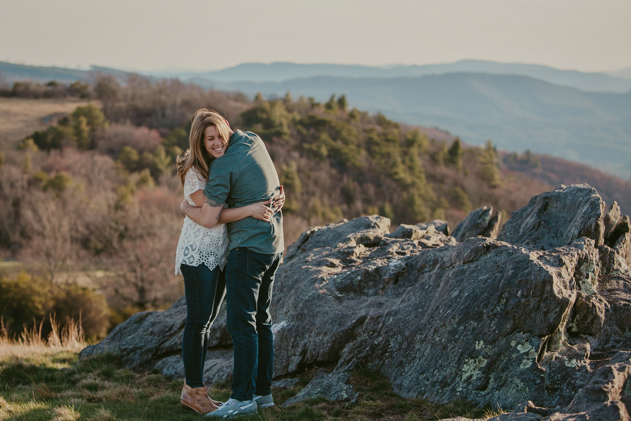 Married couple snuggles atop the breathtaking Blue Ridge Parkway near Sparta, NC. Photography by Mabyn Ludke.