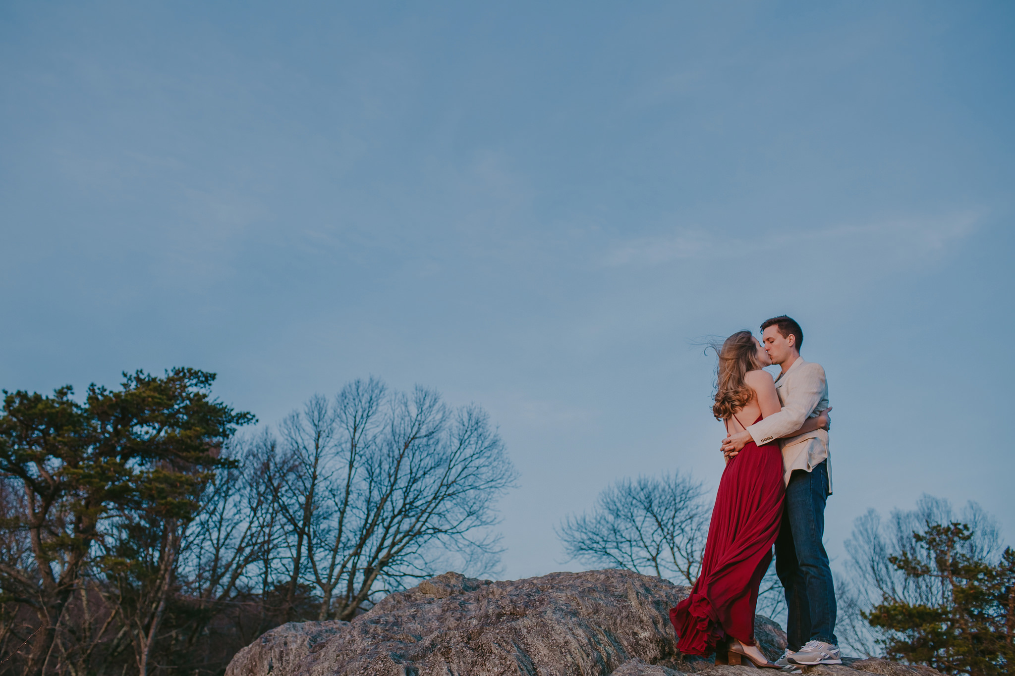 Couple kisses atop a mountain cliff in the Blue Ridge Parkway during their anniversary session by Mabyn Ludke Photography