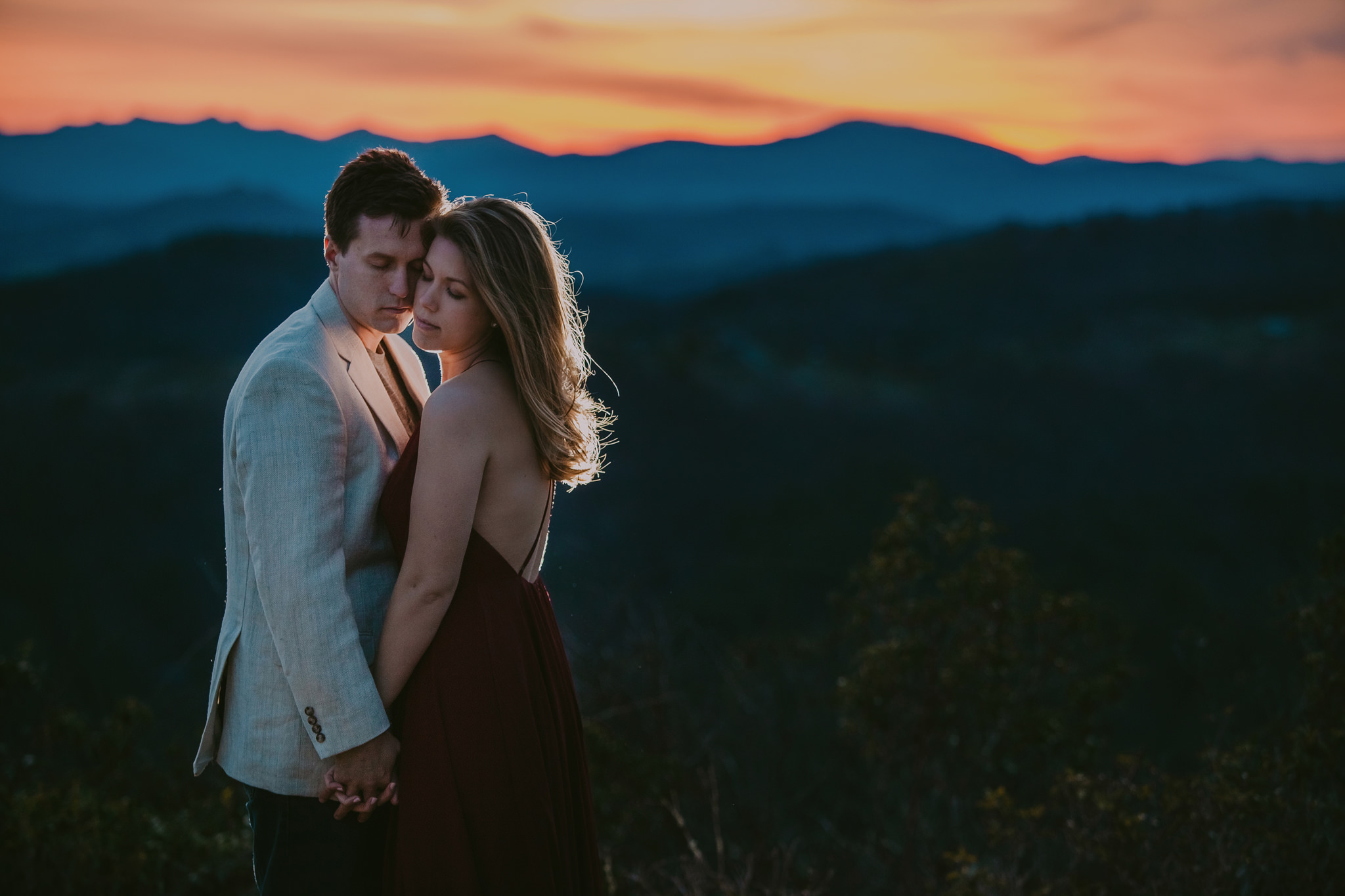 One last embrace at Doughton Park overlooking the Blue Ridge Parkway in North Carolina during a beautiful anniversary session by Mabyn Ludke Photography.