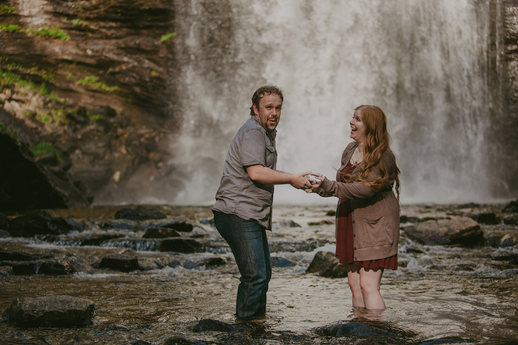 Cold water at a Looking Glass Falls engagement session with Maby Ludke Photography near Asheville, NC 