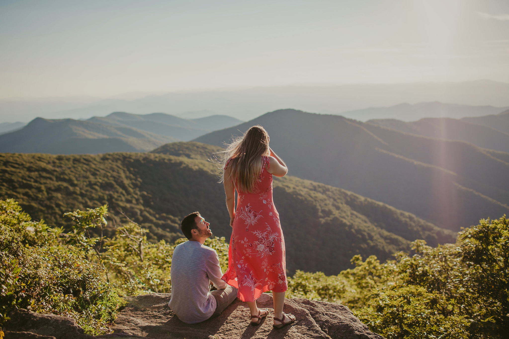 Couple takes in the beautiful mountain view at the Craggy Gardens Pinnicle in Asheville, NC