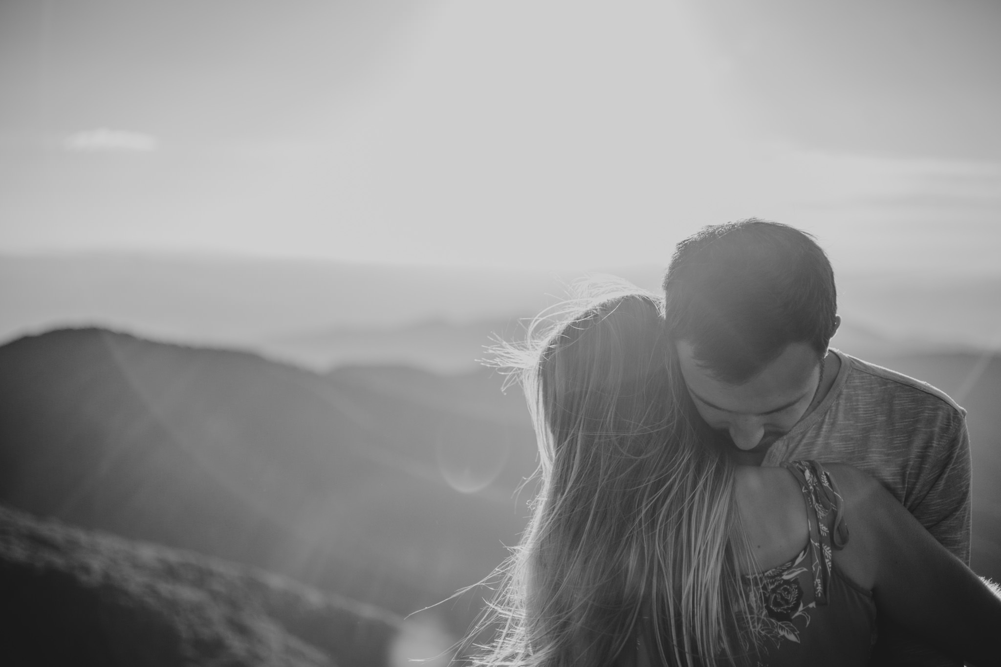 Couple hugs at the top of Craggy Gardens Pinnicle in Asheville, NC