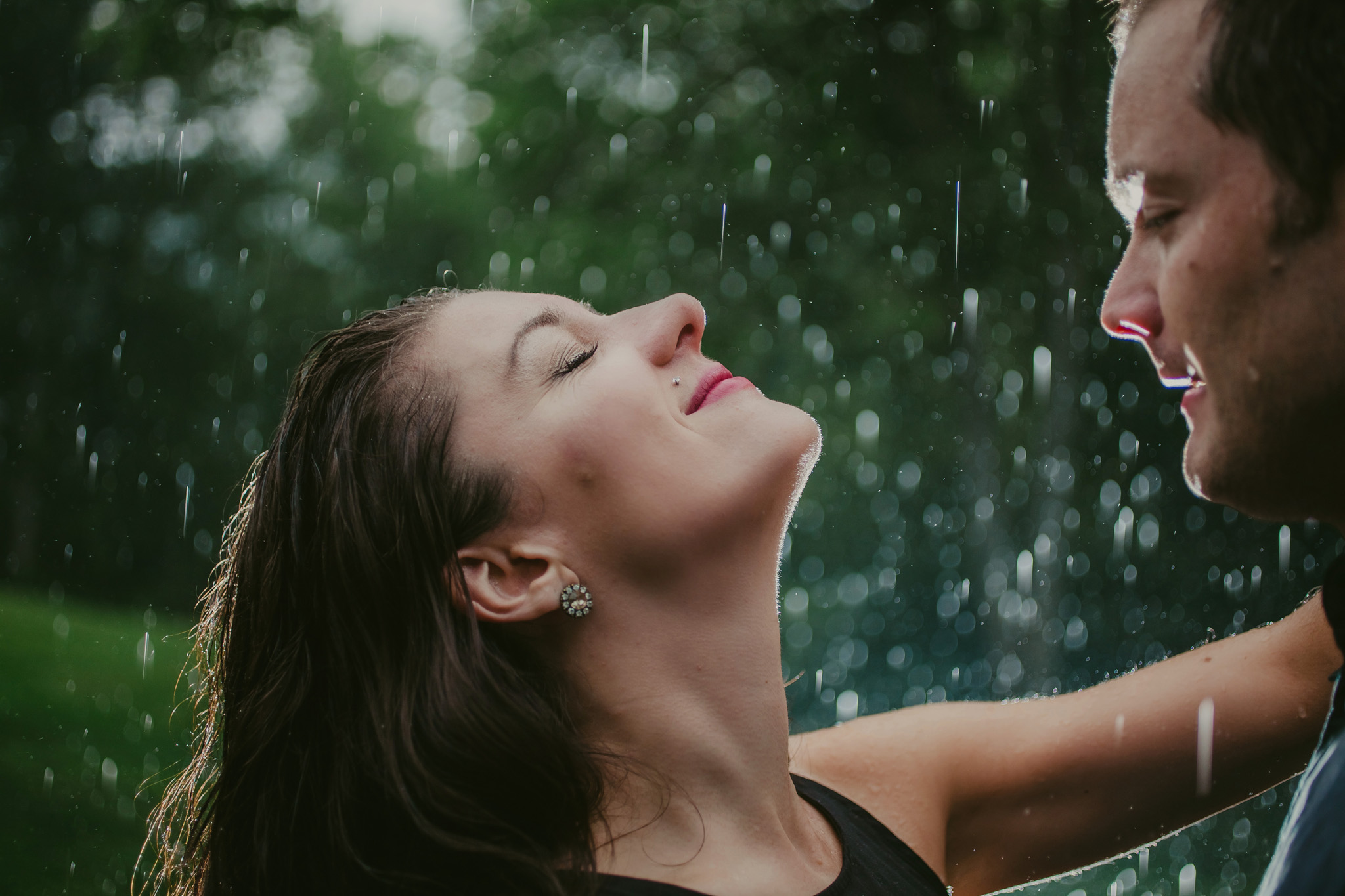 couple embraces the rain storm during their Charlotte, NC anniversary shoot