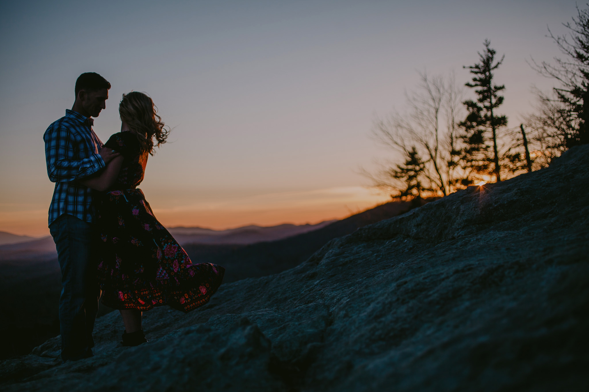 Couple watches the sunset at the Beacon Heights trail near Blowing Rock, NC