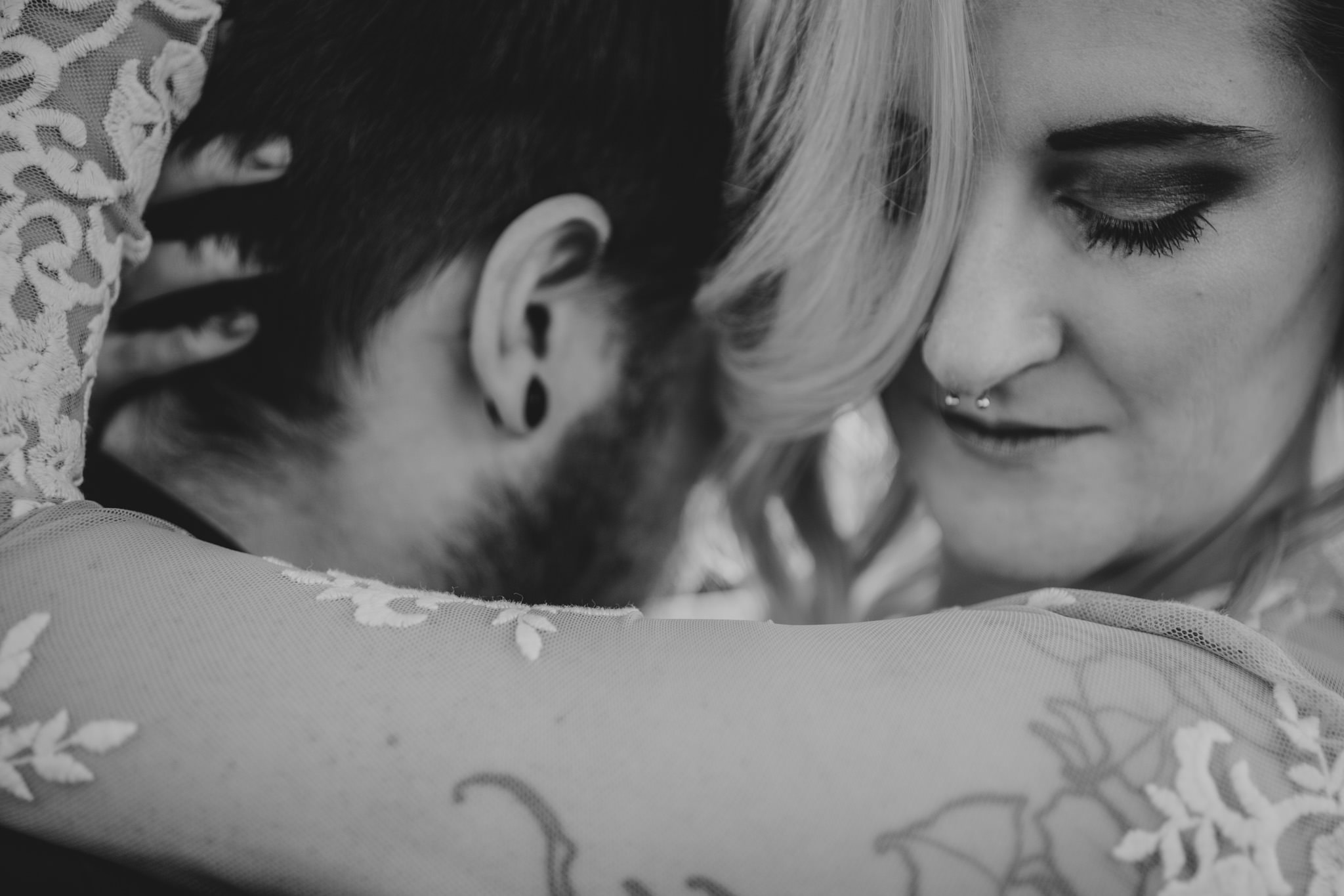 A black and white close up of this gorgeous couple during their NoDa maternity session