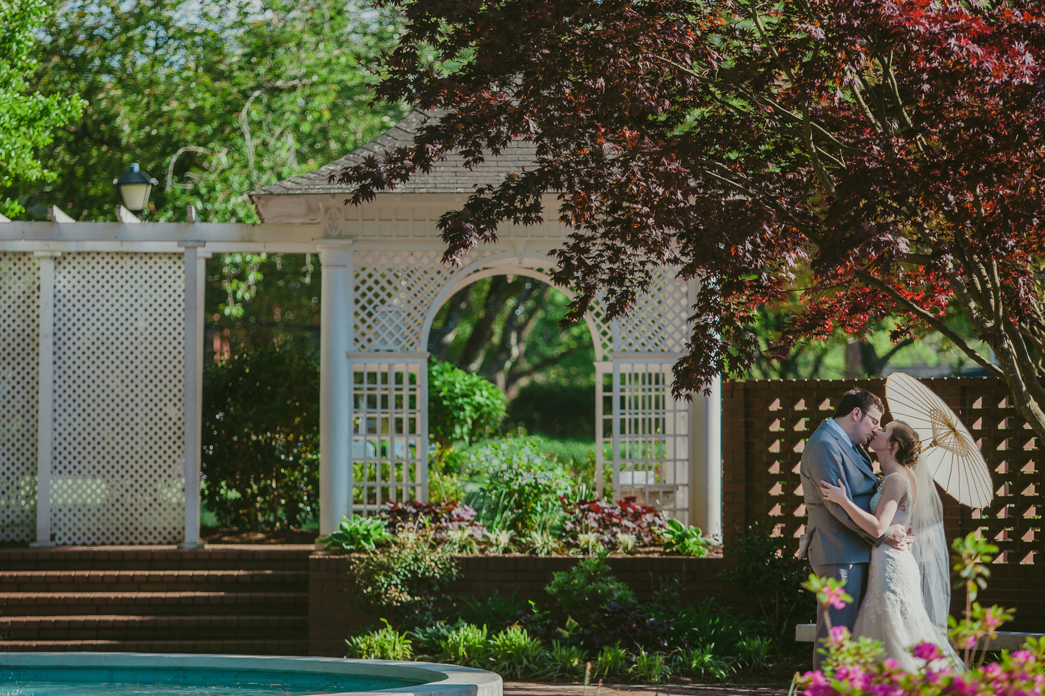 bride and groom share a romantic kiss in the gardens at the Shuford House in Hickory, NC