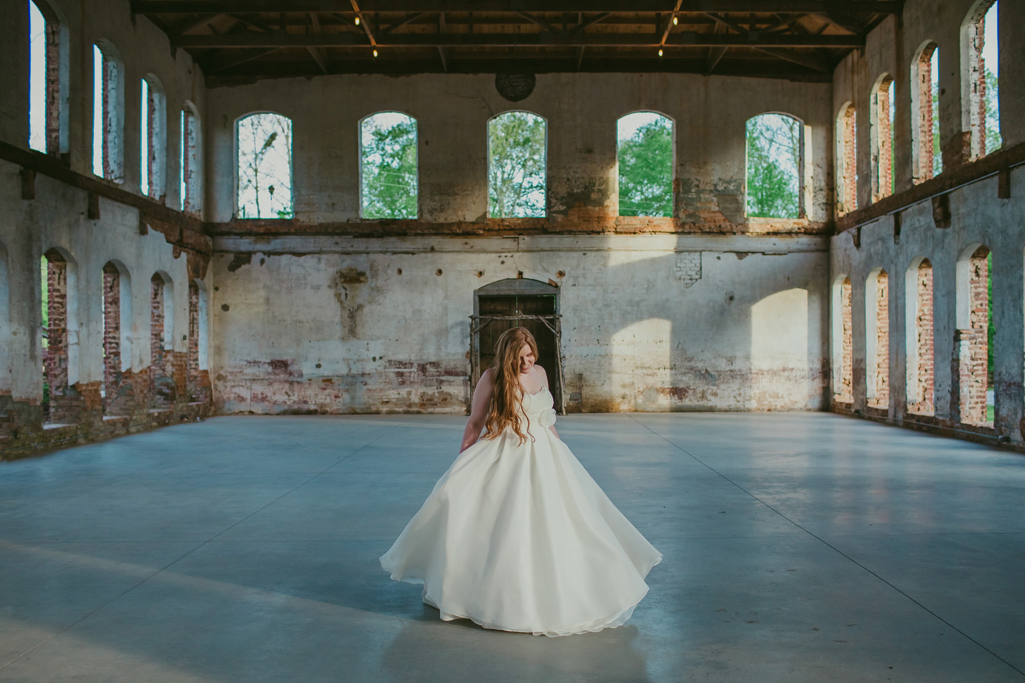 A bride twirls in her wedding gown at the Providence Cotton Mill in Maiden, NC