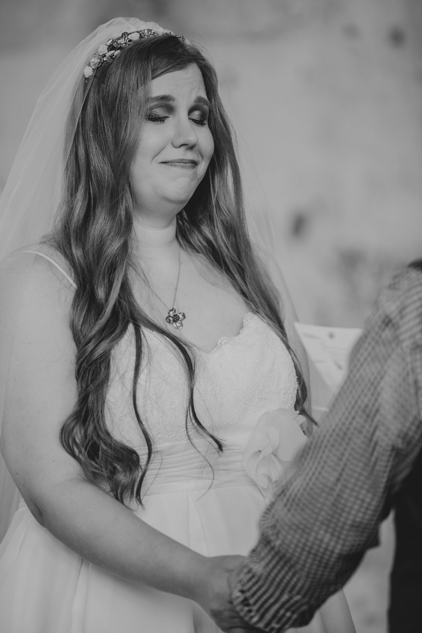 Bride gets emotional during their wedding ceremony at the Providence Cotton Mill