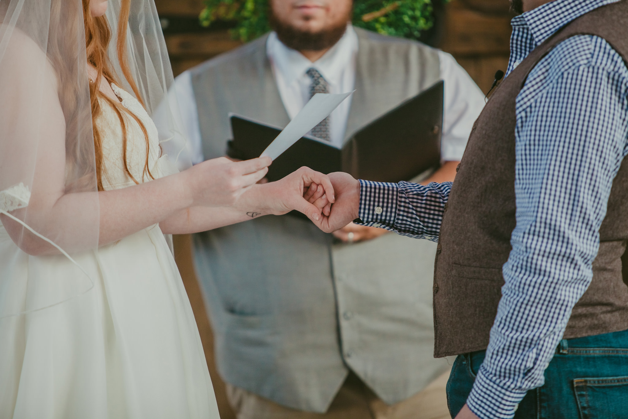 Couple holds hands during their elopement at the Providence Cotton Mill