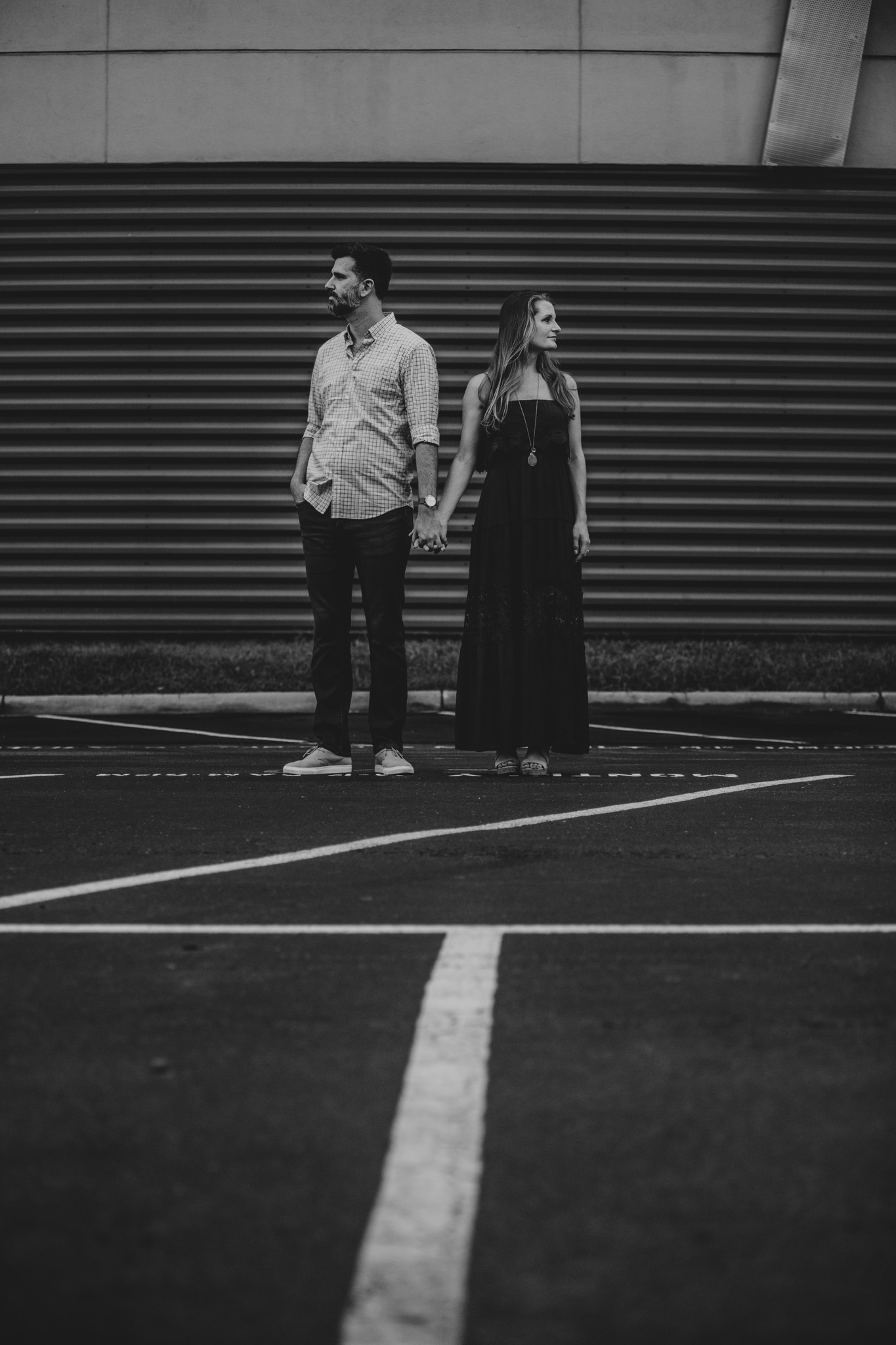 An artsy black and white photo of an engaged couple in Uptown Charlotte