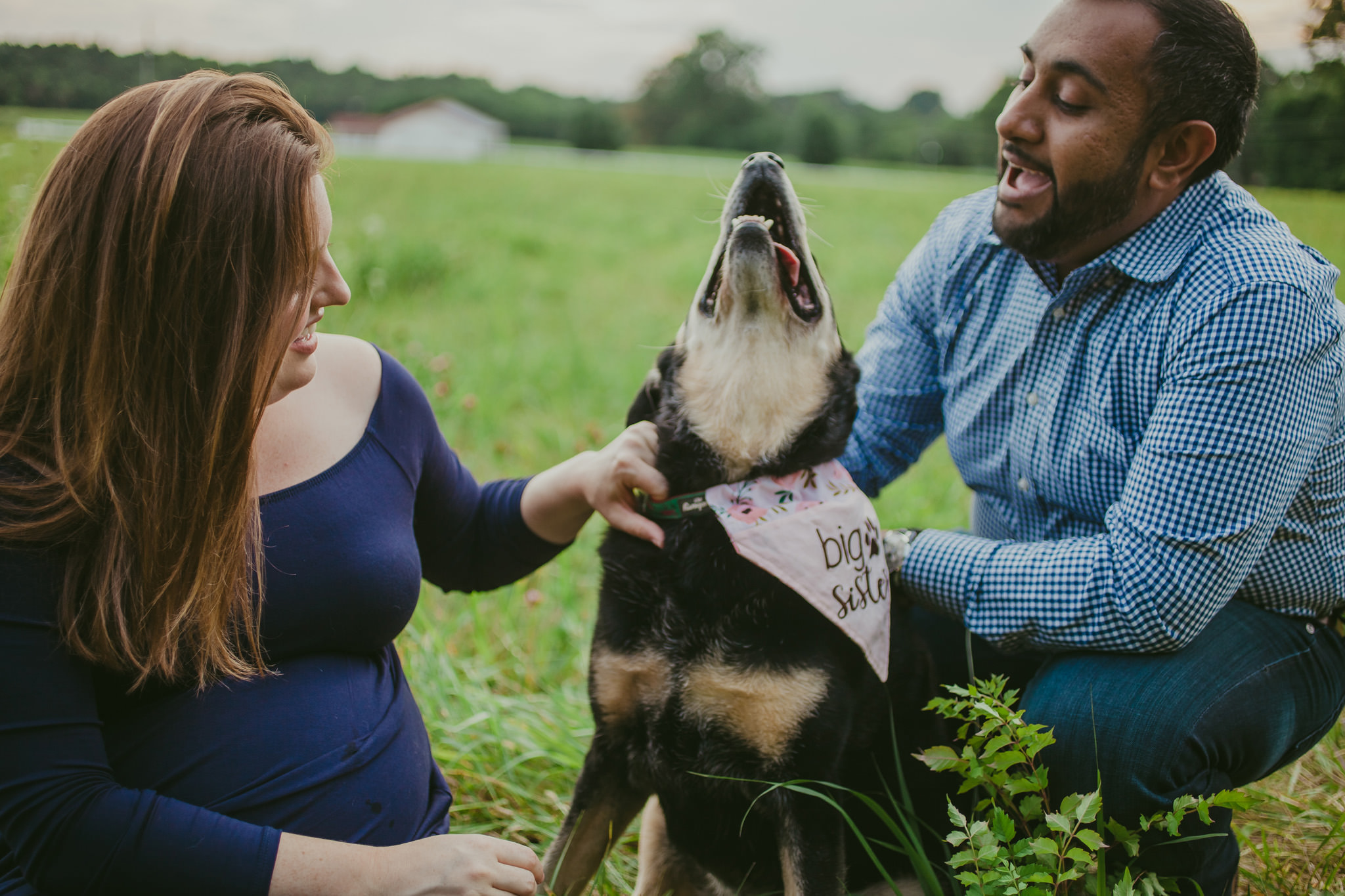 Couple laughs with their dog during their Clevland, NC maternity session