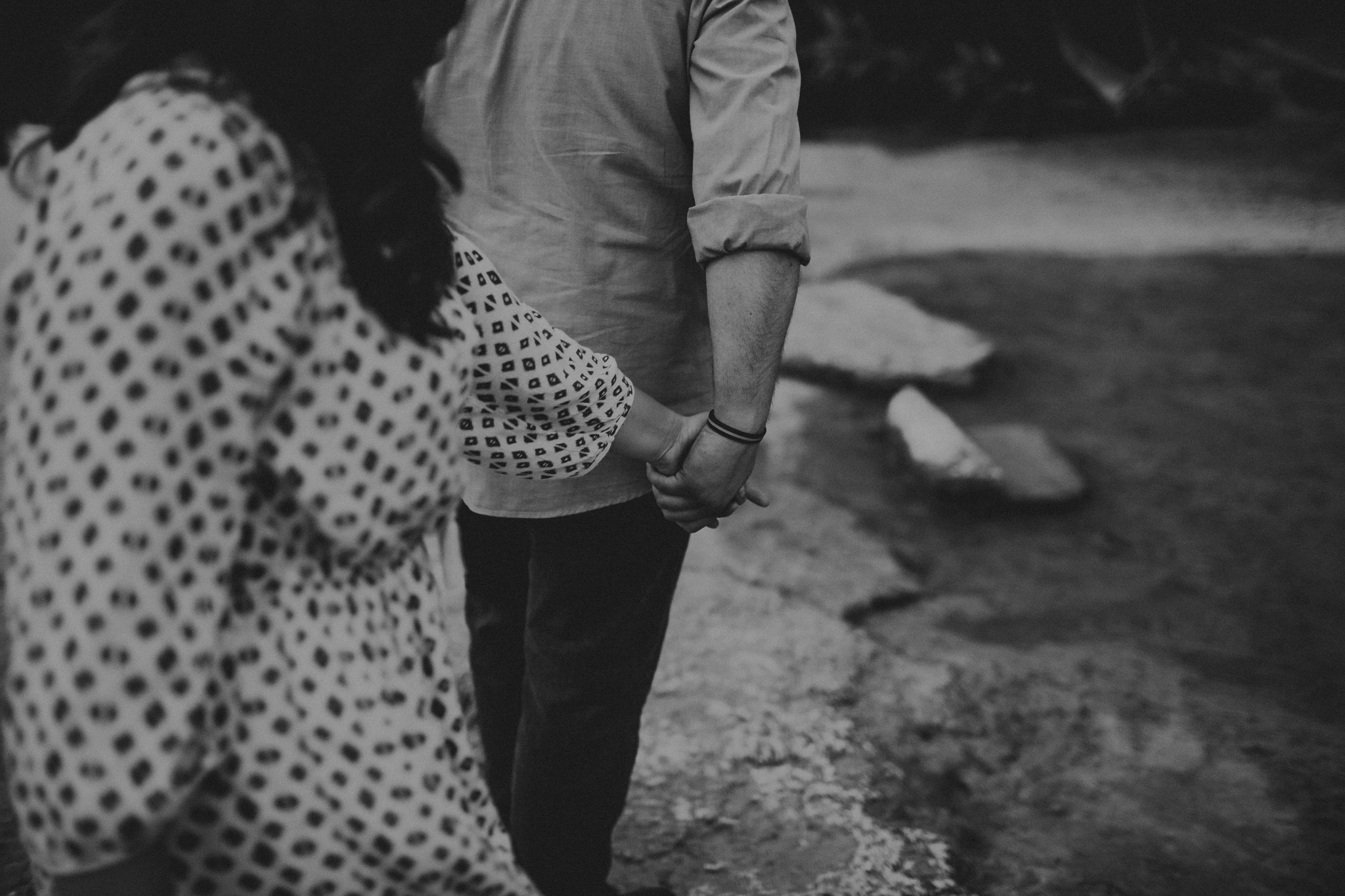 holding hands at Green Lakes State Park during an engagement session