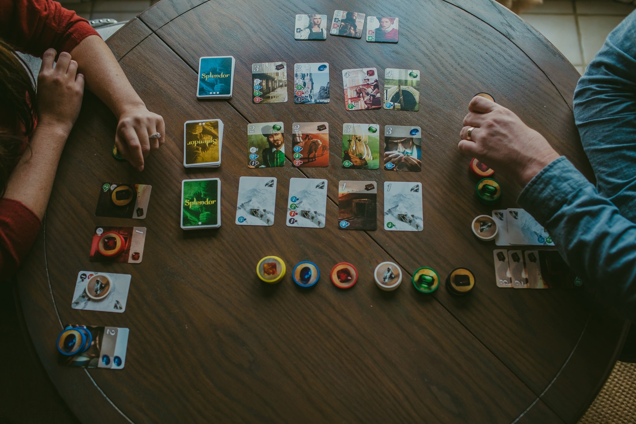 Lauren and Adam play each other in a board game for their Charlotte engagement session