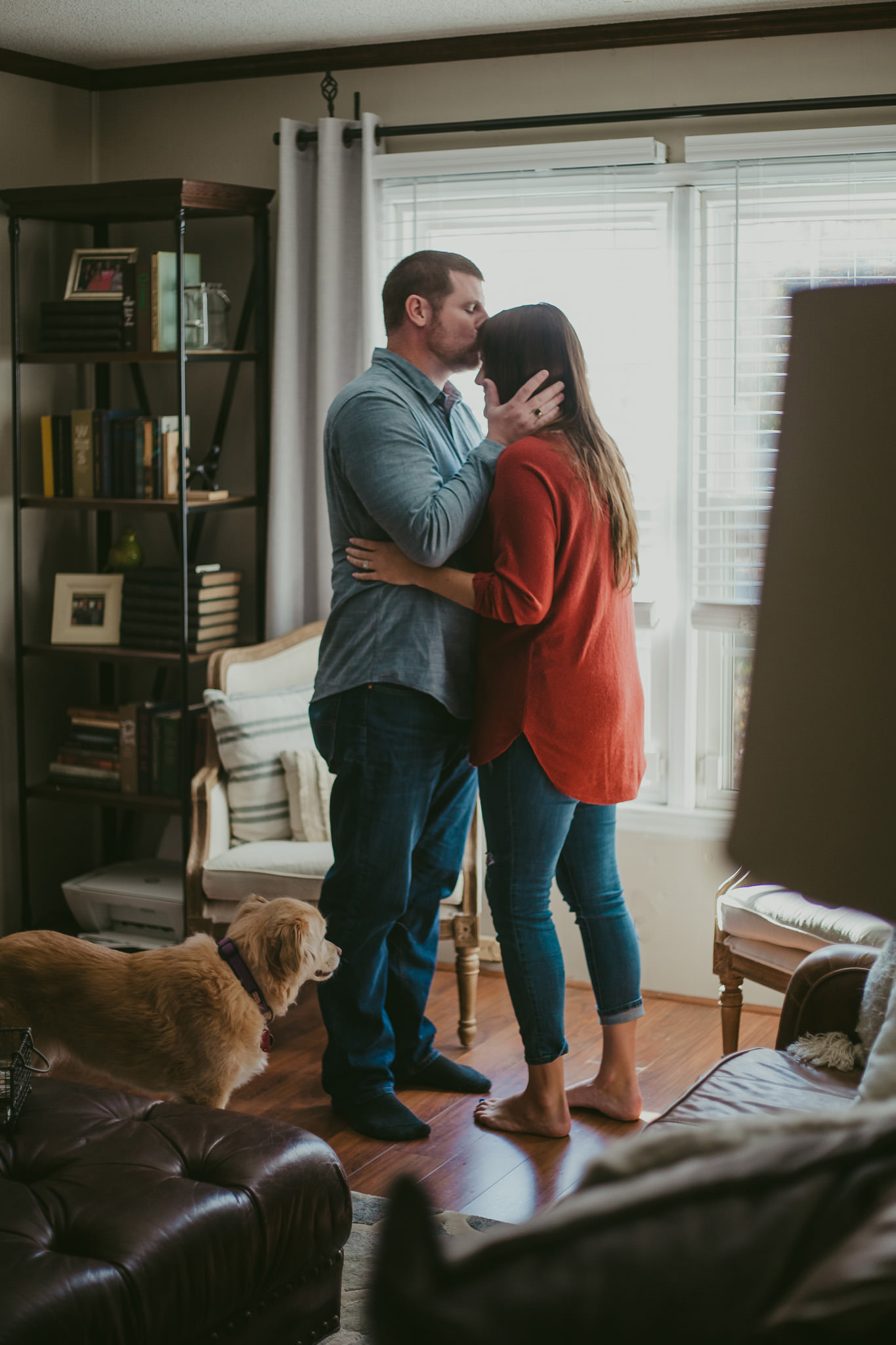 A sweet kiss at home during Lauren & Adam's Charlotte engagement session
