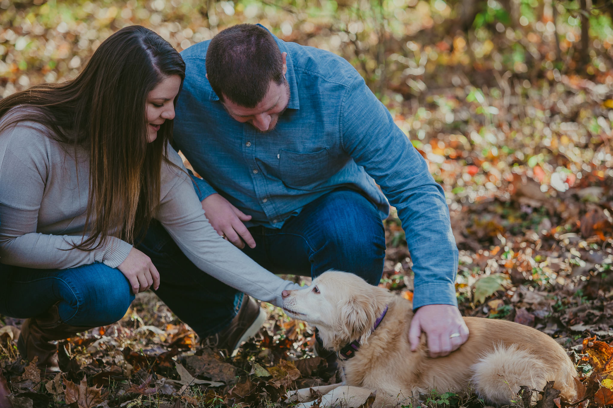 Couple plays with their pup at their Charlotte engagement session