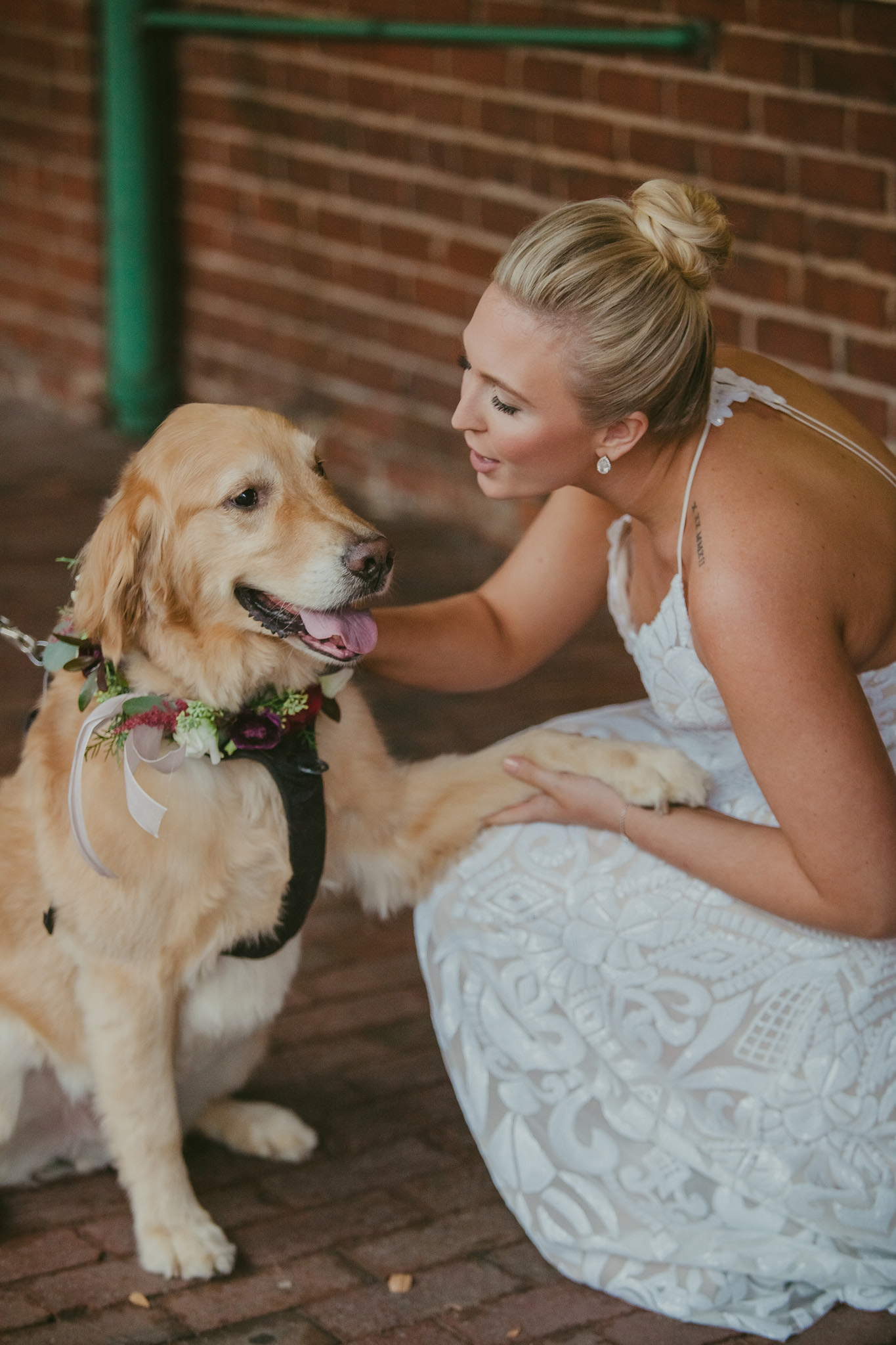 Bride shares a moment with her golden retriever before her wedding ceremony at 214 Martin St